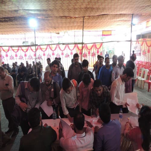Organizers assisting participants with registration at a community event desk